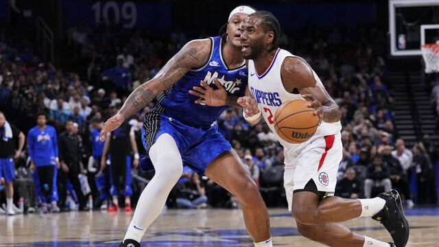 ORLANDO, FLORIDA - MARCH 29: Kawhi Leonard #2 of the LA Clippers dribbles the ball against Paolo Banchero #5 of the Orlando Magic during the third quarter at Kia Center on March 29, 2024 in Orlando, Florida.