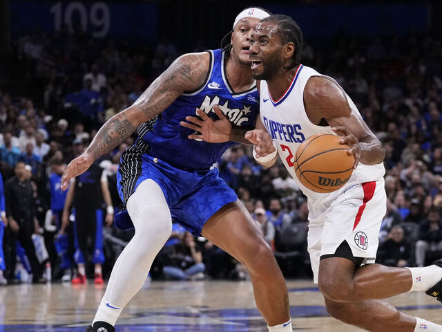 ORLANDO, FLORIDA - MARCH 29: Kawhi Leonard #2 of the LA Clippers dribbles the ball against Paolo Banchero #5 of the Orlando Magic during the third quarter at Kia Center on March 29, 2024 in Orlando, Florida.