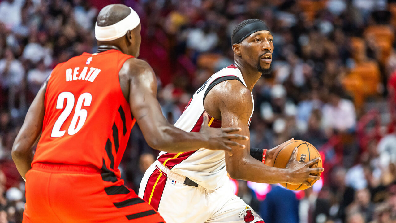 MIAMI, FLORIDA - MARCH 29: Bam Adebayo 13 of the Miami Heat looks to pass the ball against Duop Reath #26 of the Portland Trail Blazers during the second half at the Kaseya Center on March 29, 2024 in Miami, Florida.