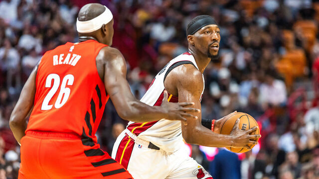 MIAMI, FLORIDA - MARCH 29: Bam Adebayo 13 of the Miami Heat looks to pass the ball against Duop Reath #26 of the Portland Trail Blazers during the second half at the Kaseya Center on March 29, 2024 in Miami, Florida.