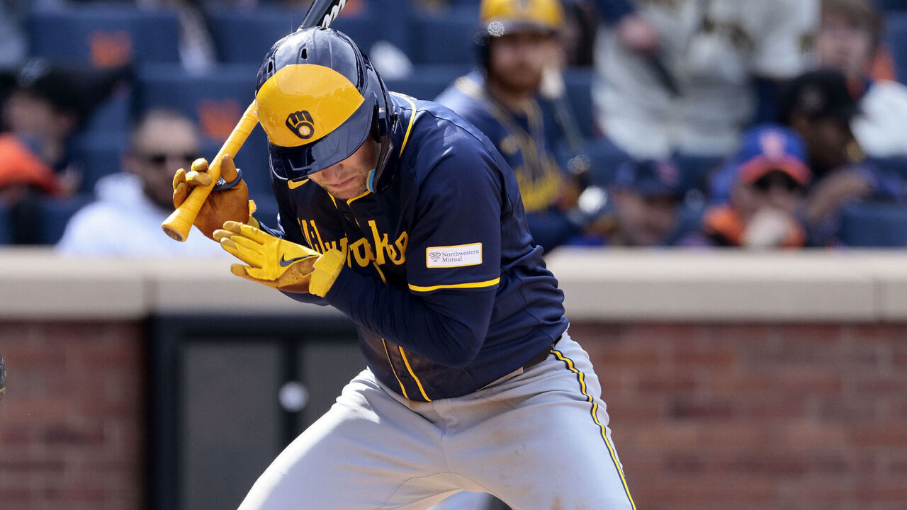 NEW YORK, NEW YORK - MARCH 30: Rhys Hoskins #12 of the Milwaukee Brewers ducks out of the way of a pitch thrown by Yohan Ramírez #46 of the New York Mets during the top of the seventh inning at Citi Field on March 30, 2024 in New York City.