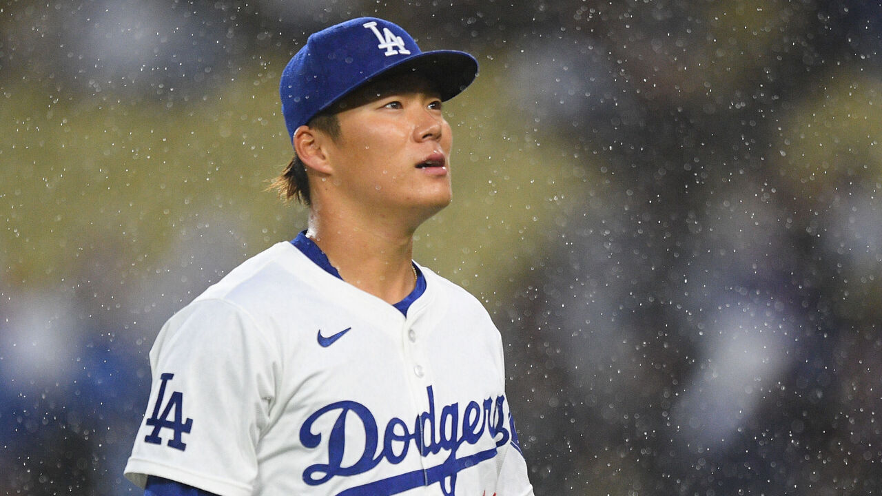 LOS ANGELES, CA - MARCH 30: Los Angeles Dodgers pitcher Yoshinobu Yamamoto (18) looks on in the rain during the MLB game between the St. Louis Cardinals and the Los Angeles Dodgers on March 30, 2024 at Dodger Stadium in Los Angeles, CA.