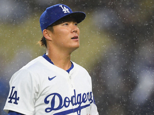 LOS ANGELES, CA - MARCH 30: Los Angeles Dodgers pitcher Yoshinobu Yamamoto (18) looks on in the rain during the MLB game between the St. Louis Cardinals and the Los Angeles Dodgers on March 30, 2024 at Dodger Stadium in Los Angeles, CA.