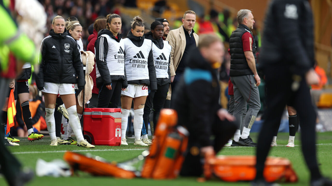WOLVERHAMPTON, ENGLAND - MARCH 31: Players of Arsenal and Jonas Eidevall, Manager of Arsenal, look on as Frida Maanum of Arsenal (not pictured) receives medical treatment during the FA Women's Continental Tyres League Cup Final match between Arsenal and Chelsea at Molineux on March 31, 2024 in Wolverhampton, England.