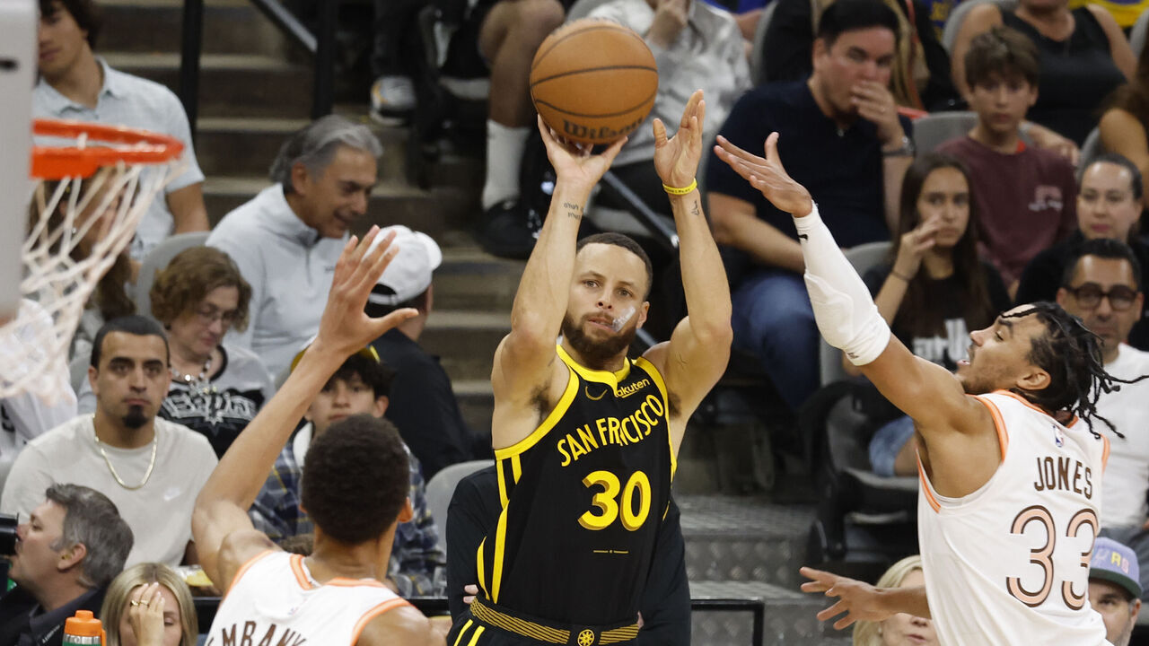 SAN ANTONIO, TX - MARCH 31: Stephen Curry #30 of the Golden State Warriors hits a three by Tre Jones #33 of the San Antonio Spursin the first half at Frost Bank Center on March 31, 2024 in San Antonio, Texas. NOTE TO USER: User expressly acknowledges and agrees that, by downloading and or using this photograph, User is consenting to terms and conditions of the Getty Images License Agreement.