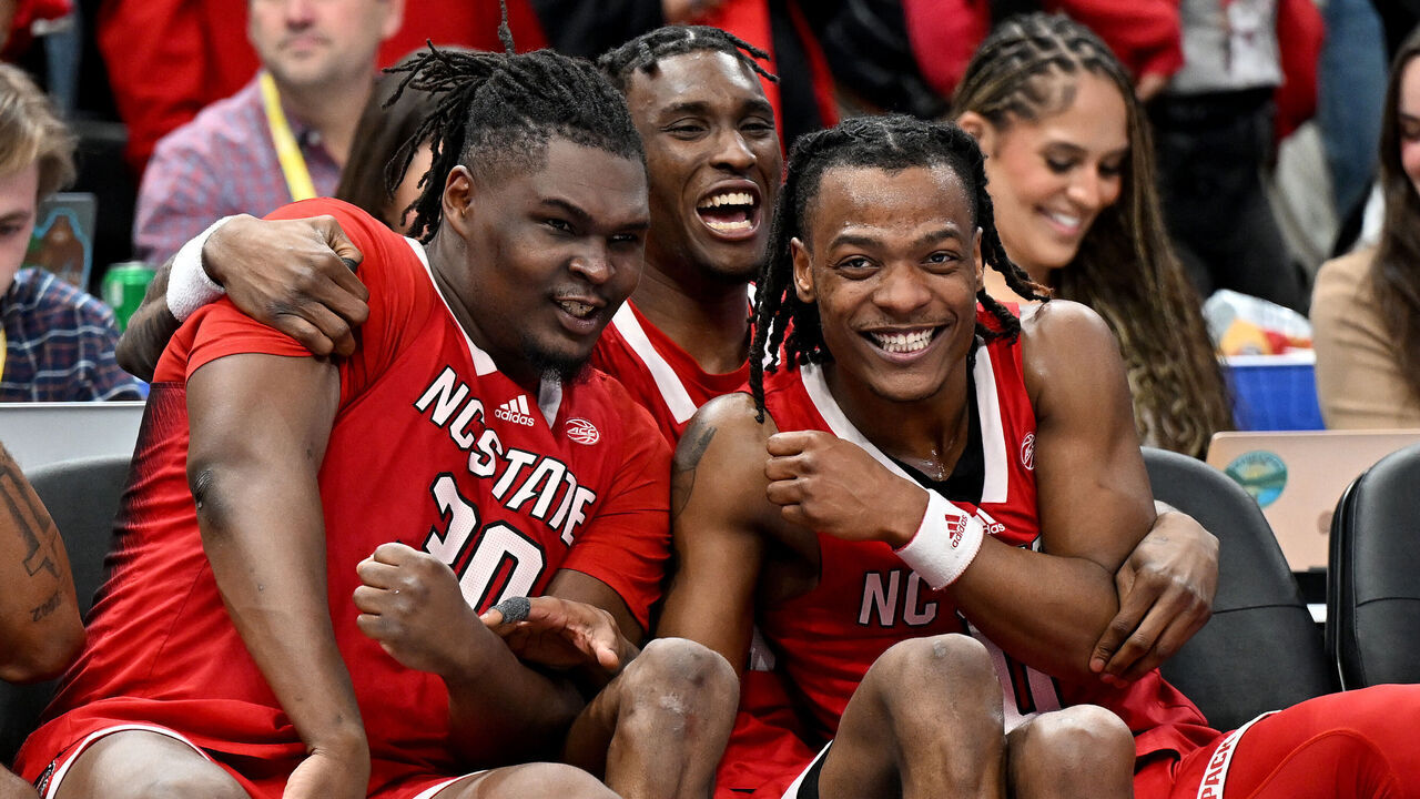WASHINGTON, DC - MARCH 16: DJ Burns Jr. #30, Ernest Ross #24 and DJ Horne #0 of the North Carolina State Wolfpack celebrate in the second half against the North Carolina Tar Heels in the Championship Game of the ACC Men's Basketball Tournament at Capital One Arena on March 16, 2024 in Washington, DC.