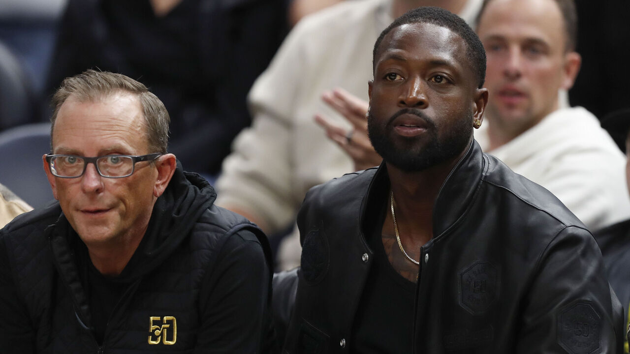 SALT LAKE CITY, UT - OCTOBER 27: Justin Zanik general manager of the Utah Jazz sits with minority owner Dwayne Wade during the second half of their game against the Los Angeles Clippers at the Delta Center on October 26 2023 in Sandy, Utah.