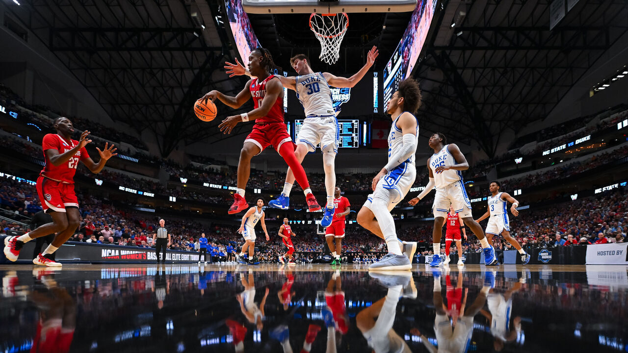 DALLAS, TEXAS - MARCH 31: DJ Horne #0 of the North Carolina State Wolfpack passes to Mohamed Diarra #23 of the North Carolina State Wolfpack during the Elite Eight round of the 2024 NCAA Men's Basketball Tournament held at American Airlines Center on March 31, 2024 in Dallas, Texas.