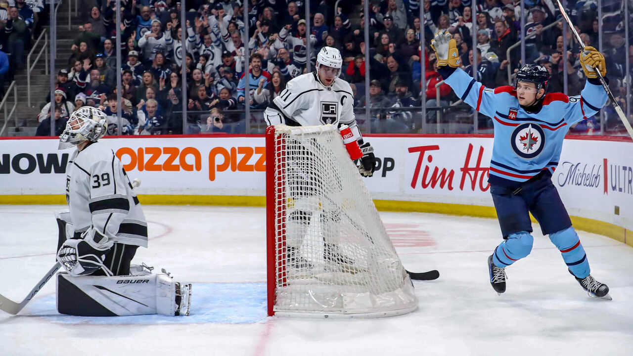 WINNIPEG, CANADA - APRIL 1: Cole Perfetti #91 of the Winnipeg Jets celebrates a second period goal by teammate Sean Monahan #23 (not seen) against the Los Angeles Kings at the Canada Life Centre on April 1, 2024 in Winnipeg, Manitoba, Canada.