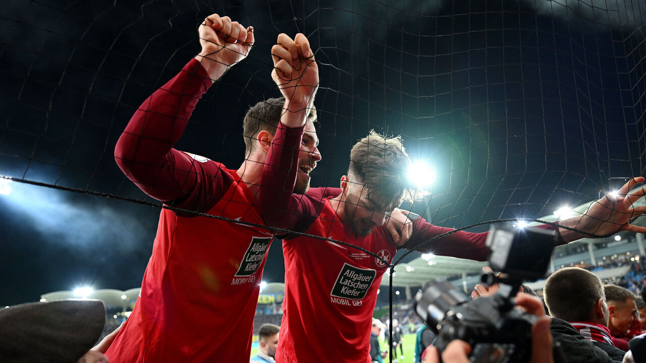 SAARBRUECKEN, GERMANY - APRIL 02: Boris Tomiak and Julian Niehues of 1. FC Kaiserslautern celebrate with the fans after the team's victory during the DFB Cup semifinal match between 1. FC Saarbrücken and 1. FC Kaiserslautern at the Ludwigsparkstadion on April 02, 2024 in Saarbruecken, Germany.