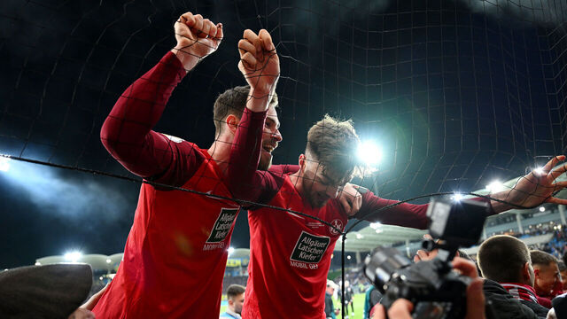 SAARBRUECKEN, GERMANY - APRIL 02: Boris Tomiak and Julian Niehues of 1. FC Kaiserslautern celebrate with the fans after the team's victory during the DFB Cup semifinal match between 1. FC Saarbrücken and 1. FC Kaiserslautern at the Ludwigsparkstadion on April 02, 2024 in Saarbruecken, Germany.