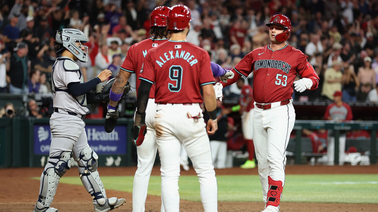 PHOENIX, ARIZONA - APRIL 02: Christian Walker #53 of the Arizona Diamondbacks high fives Ketel Marte #4 and Blaze Alexander #9 after hitting a three-run home run against the New York Yankees during the seventh inning of the MLB game at Chase Field on April 02, 2024 in Phoenix, Arizona.
