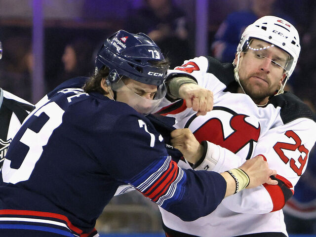 NEW YORK, NEW YORK - APRIL 03: Kurtis MacDermid #23 of the New Jersey Devils fights with Matt Rempe #73 of the New York Rangers during the first period at Madison Square Garden on April 03, 2024 in New York City.