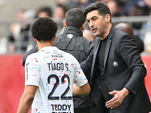 Lille's Portuguese head coach Paulo Fonseca (R) speaks with Lille's Portuguese defender #22 Tiago Santos during the French L1 football match between Stade de Reims and Lille LOSC at the Stade Auguste-Delaune in Reims, northern France on March 2, 2024.