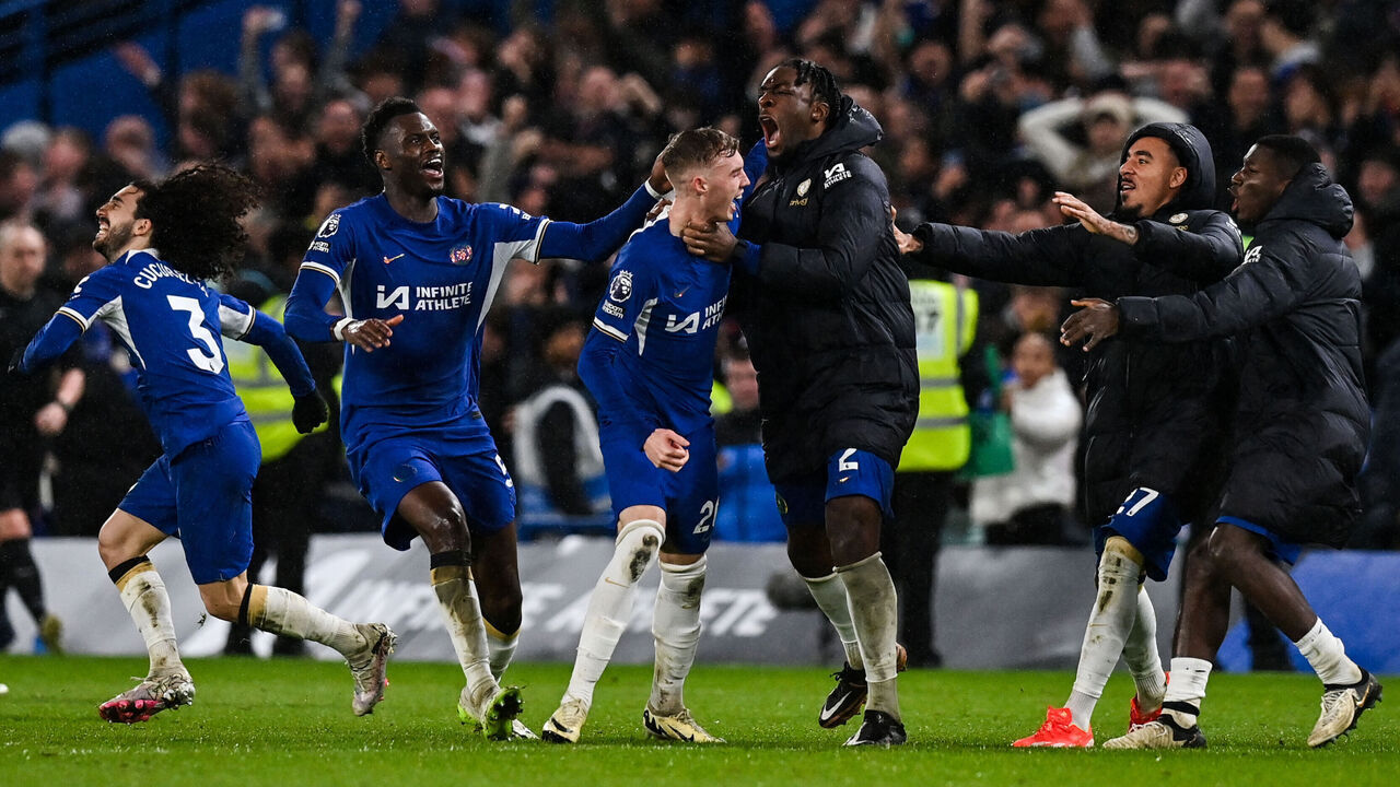 Chelsea's English midfielder #20 Cole Palmer (C) celebrates with teammates after scoring the fourth and winning goal of his team during the English Premier League football match between Chelsea and Manchester United at Stamford Bridge in London on April 4, 2024.