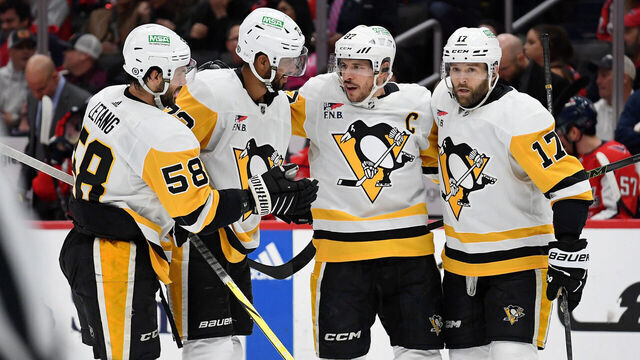 WASHINGTON, DC - APRIL 04: Penguins defenseman Kris Letang (58), defenseman Pierre-Olivier Joseph (73), center Sidney Crosby (87), and right wing Bryan Rust (17) celebrate after Joseph's first period goal during the Pittsburgh Penguins versus Washington Capitals National Hockey League game on April 4, 2024 at Capital One Arena in Washington, D.C..