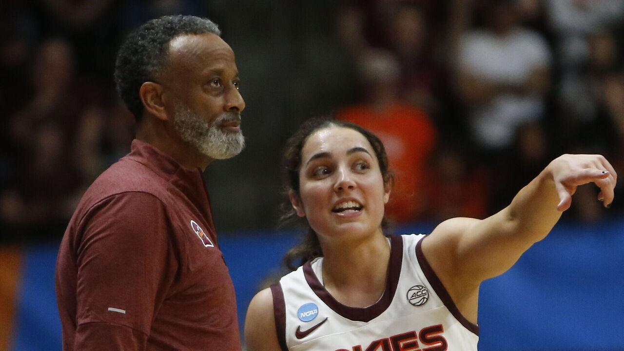 BLACKSBURG, VA - MARCH 22: Virginia Tech Hokies Head Coach Kenny Brooks and guard Georgia Amoore (5) chat on the sidelines during the Marshall Thundering Herd game versus the Virginia Tech Hokies in the first round of the NCAA Division I Women's Championship on March 22, 2024, at Cassell Coliseum in Blacksburg, VA.