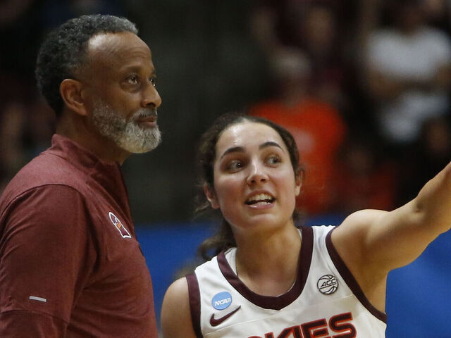 BLACKSBURG, VA - MARCH 22: Virginia Tech Hokies Head Coach Kenny Brooks and guard Georgia Amoore (5) chat on the sidelines during the Marshall Thundering Herd game versus the Virginia Tech Hokies in the first round of the NCAA Division I Women's Championship on March 22, 2024, at Cassell Coliseum in Blacksburg, VA.