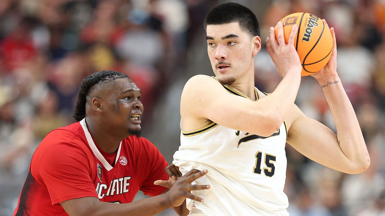 GLENDALE, ARIZONA - APRIL 06: Zach Edey #15 of the Purdue Boilermakers handles the ball while being guarded by DJ Burns Jr. #30 of the North Carolina State Wolfpack in the first half in the NCAA Men's Basketball Tournament Final Four semifinal game at State Farm Stadium on April 06, 2024 in Glendale, Arizona.