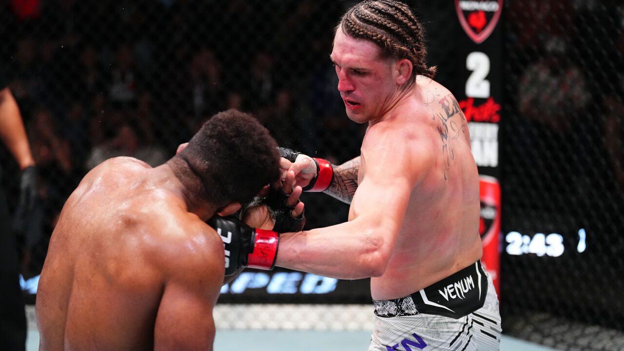 LAS VEGAS, NEVADA - APRIL 06: (R-L) Brendan Allen punches Chris Curtis in a middleweight fight during the UFC Fight Night event at UFC APEX on April 06, 2024 in Las Vegas, Nevada.