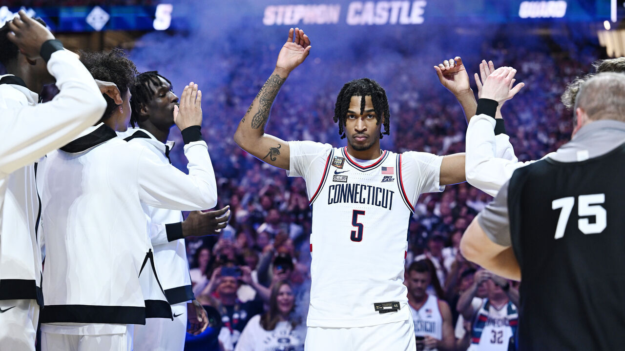 GLENDALE, ARIZONA - APRIL 06: Stephon Castle #5 of the Connecticut Huskies high fives teammates prior to the first half in the NCAA Men’s Basketball Tournament Final Four semifinal game at State Farm Stadium on April 06, 2024 in Glendale, Arizona.