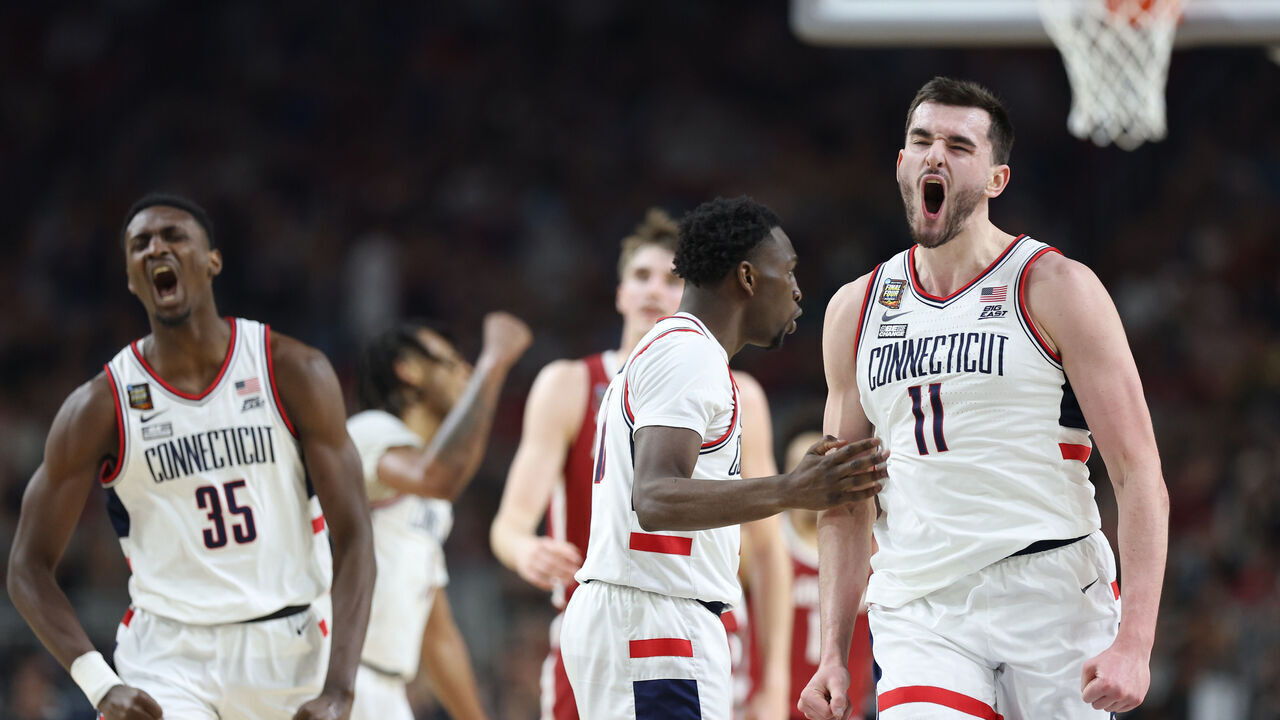 GLENDALE, ARIZONA - APRIL 06: Hassan Diarra #10 and Alex Karaban #11 of the Connecticut Huskies celebrate in the second half against the Alabama Crimson Tide in the NCAA Men's Basketball Tournament Final Four semifinal game at State Farm Stadium on April 06, 2024 in Glendale, Arizona.