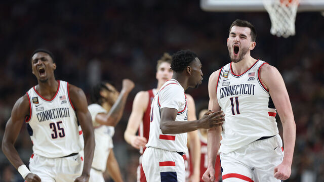 GLENDALE, ARIZONA - APRIL 06: Hassan Diarra #10 and Alex Karaban #11 of the Connecticut Huskies celebrate in the second half against the Alabama Crimson Tide in the NCAA Men's Basketball Tournament Final Four semifinal game at State Farm Stadium on April 06, 2024 in Glendale, Arizona.
