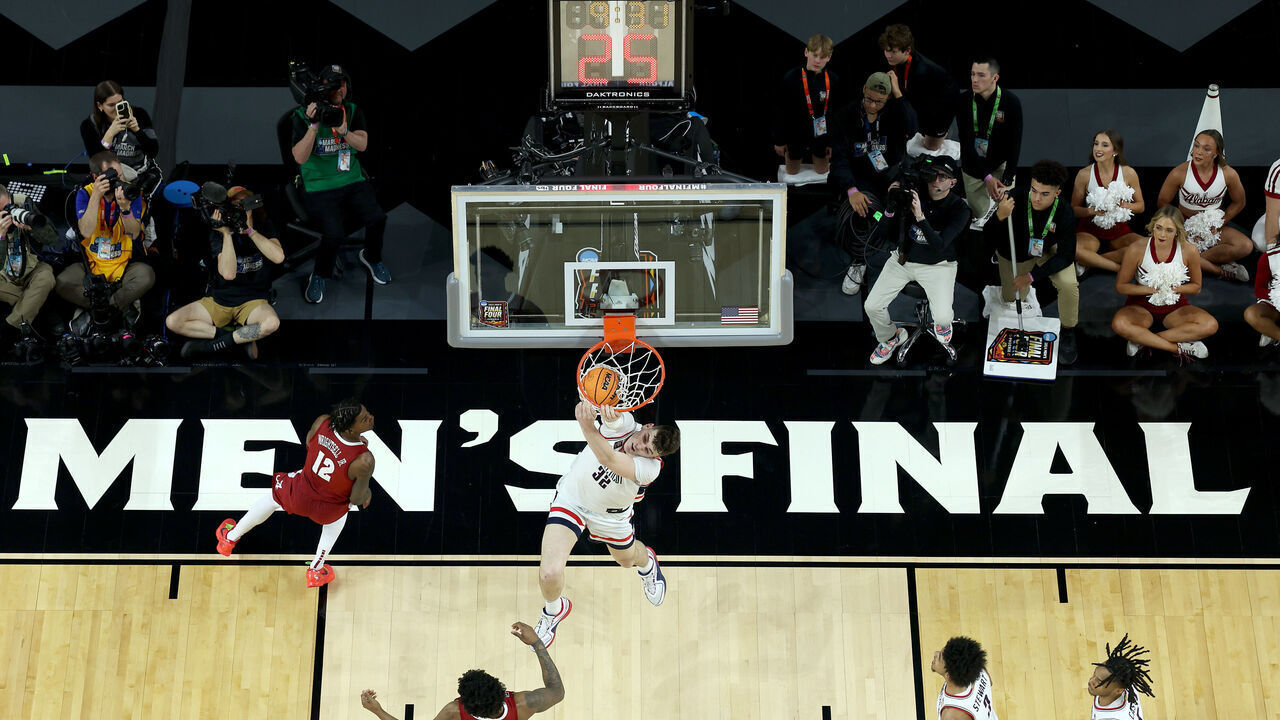 GLENDALE, ARIZONA - APRIL 06: (EDITORS NOTE: Image taken using a remote camera.) Donovan Clingan #32 of the Connecticut Huskies dunk during the first half in the NCAA Men’s Basketball Tournament Final Four semifinal game against the Alabama Crimson Tide at State Farm Stadium on April 06, 2024 in Glendale, Arizona.