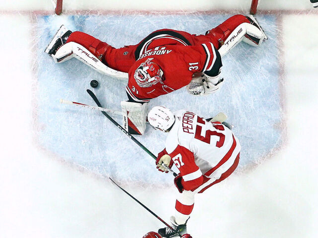 RALEIGH, NORTH CAROLINA - MARCH 28: Frederik Andersen #31 of the Carolina Hurricanes makes a save against David Perron #57 of the Detroit Red Wings during the first period of the game at PNC Arena on March 28, 2024 in Raleigh, North Carolina.
