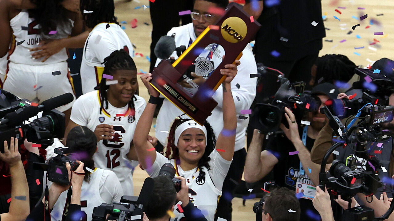 CLEVELAND, OHIO - APRIL 07: Te-Hina Paopao #0 of the South Carolina Gamecocks hoists the trophy after beating the Iowa Hawkeyes in the 2024 NCAA Women's Basketball Tournament National Championship at Rocket Mortgage FieldHouse on April 07, 2024 in Cleveland, Ohio. Iowa beat South Carolina 87-75.