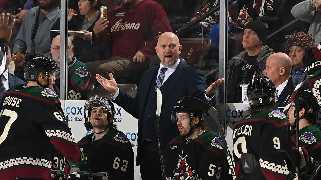 TEMPE, ARIZONA - JANUARY 02: Arizona Coyotes Head Coach Andre Tourigny talks with Clayton Keller #9 during the first period of the game against the Florida Panthers at Mullett Arena on January 02, 2024 in Tempe, Arizona.