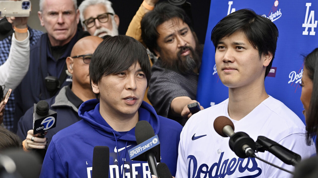 Los Angeles, CA - February 03: Shohei Ohtani, right, of the Los Angeles Dodgers speaks to the media with the help of his interpreter Ippei Mizuhara during DodgerFest a celebration of the upcoming season with live entertainment, behind-the-scenes experiences, food, drinks and meeting the newest Dodgers at Dodger Stadium in Los Angeles on Saturday, February 3, 2024.