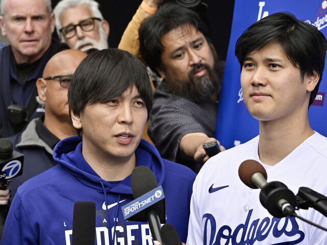 Los Angeles, CA - February 03: Shohei Ohtani, right, of the Los Angeles Dodgers speaks to the media with the help of his interpreter Ippei Mizuhara during DodgerFest a celebration of the upcoming season with live entertainment, behind-the-scenes experiences, food, drinks and meeting the newest Dodgers at Dodger Stadium in Los Angeles on Saturday, February 3, 2024.