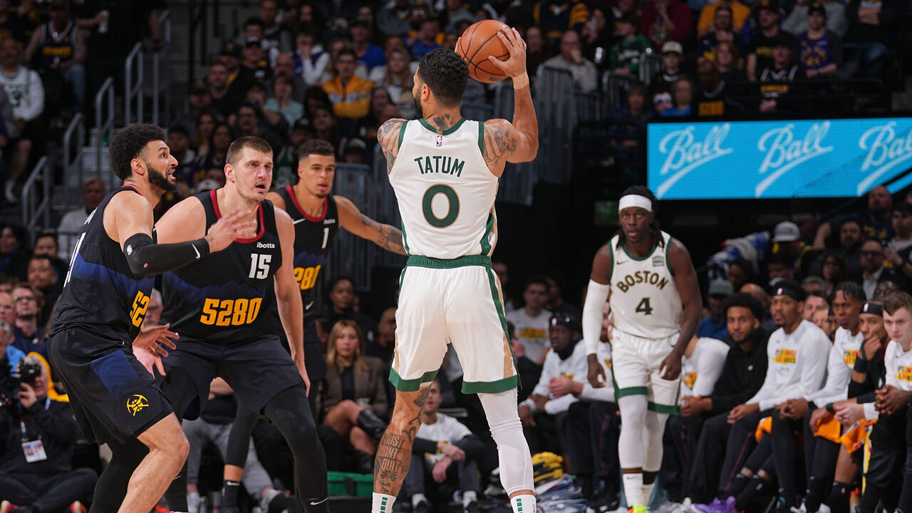 DENVER, CO - MARCH 7: Jayson Tatum #0 of the Boston Celtics handles the ball during the game as Nikola Jokic #15 of the Denver Nuggets plays defense on March 7, 2024 at the Ball Arena in Denver, Colorado. NOTE TO USER: User expressly acknowledges and agrees that, by downloading and/or using this Photograph, user is consenting to the terms and conditions of the Getty Images License Agreement. Mandatory Copyright Notice: Copyright 2024 NBAE