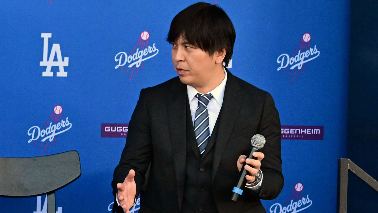 Japanese baseball player Shohei Ohtani (L) speaks alongside Japanese interpreter Ippei Mizuhara during a press conference on his presentation after signing a ten-year deal with the Los Angeles Dodgers at Dodgers Stadium in Los Angeles, California on December 14, 2023. Ohtani has signed a record-shattering $700 million deal with the Los Angeles Dodgers, the richest in North American sports history.