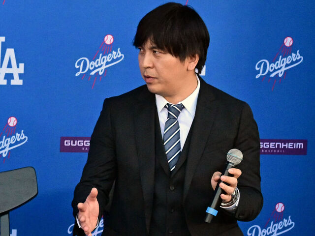 Japanese baseball player Shohei Ohtani (L) speaks alongside Japanese interpreter Ippei Mizuhara during a press conference on his presentation after signing a ten-year deal with the Los Angeles Dodgers at Dodgers Stadium in Los Angeles, California on December 14, 2023. Ohtani has signed a record-shattering $700 million deal with the Los Angeles Dodgers, the richest in North American sports history.