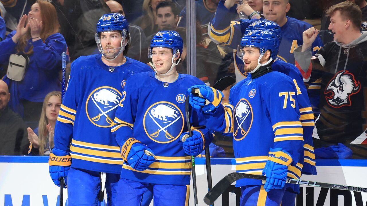 BUFFALO, NEW YORK - APRIL 11: Jack Quinn #22 of the Buffalo Sabres celebrates his third period goal against the Washington Capitals with Owen Power #25 and Connor Clifton #75 during an NHL game on April 11, 2024 at KeyBank Center in Buffalo, New York.