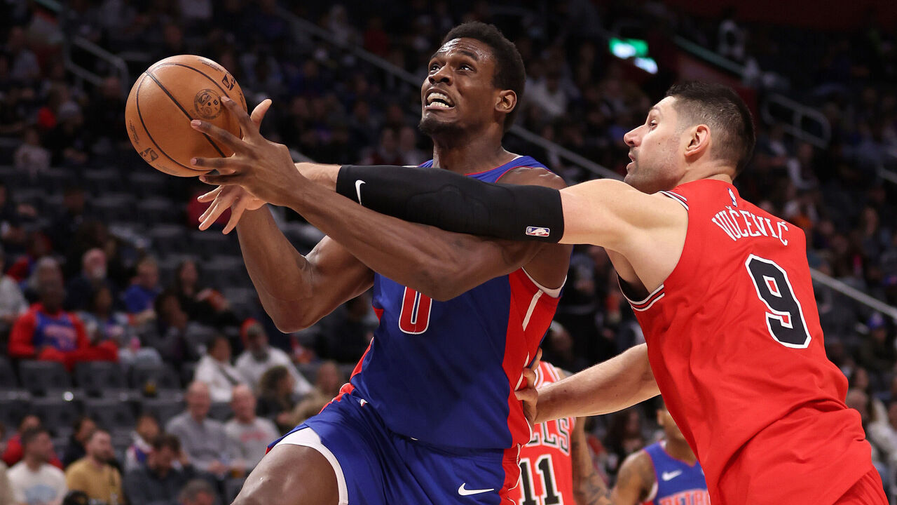 DETROIT, MICHIGAN - APRIL 11: Nikola Vucevic #9 of the Chicago Bulls fouls Jalen Duren #0 of the Detroit Pistons on his way to the basket during the first half at Little Caesars Arena on April 11, 2024 in Detroit, Michigan. NOTE TO USER: User expressly acknowledges and agrees that, by downloading and or using this photograph, User is consenting to the terms and conditions of the Getty Images License.