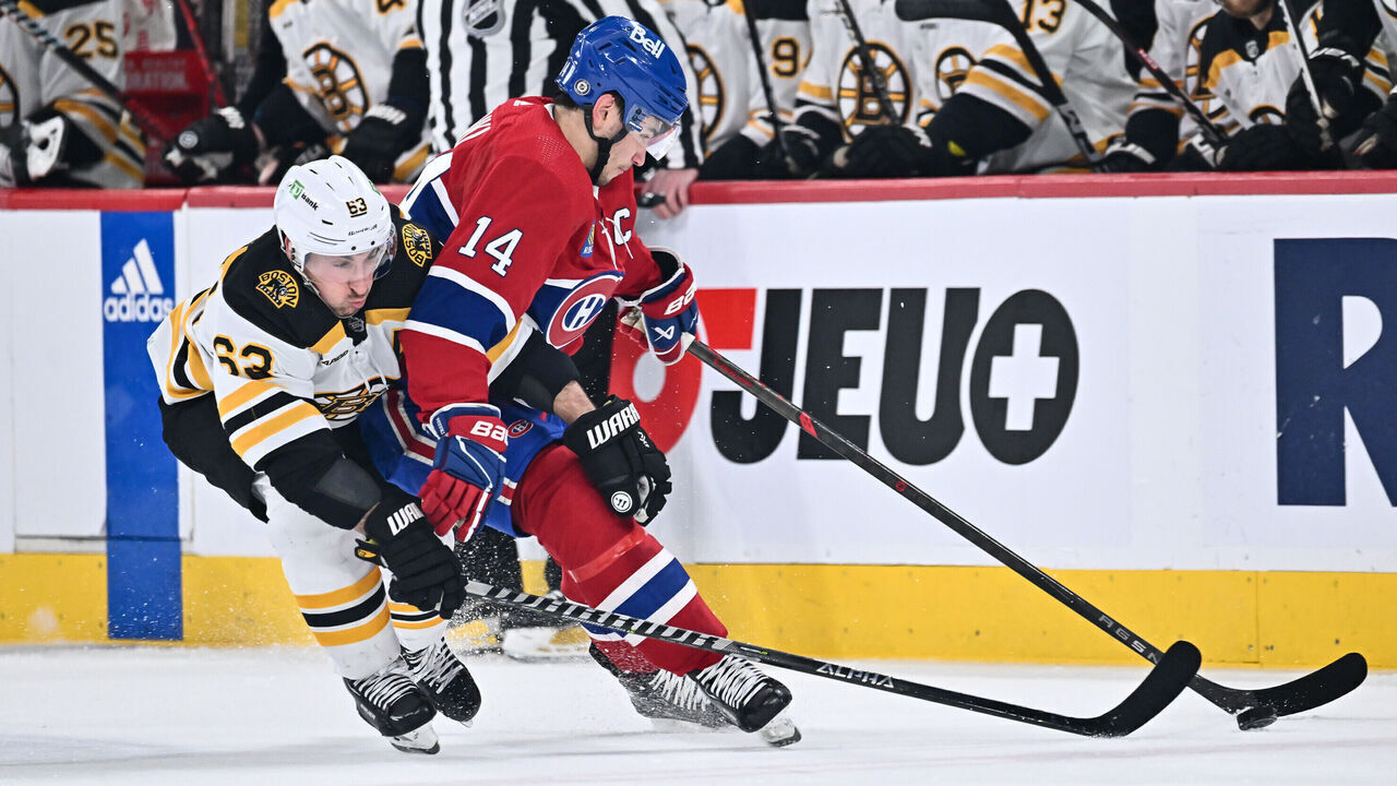 MONTREAL, CANADA - APRIL 13: Nick Suzuki #14 of the Montreal Canadiens skates the puck against Brad Marchand #63 of the Boston Bruins during the first period at Centre Bell on April 13, 2023 in Montreal, Quebec, Canada.