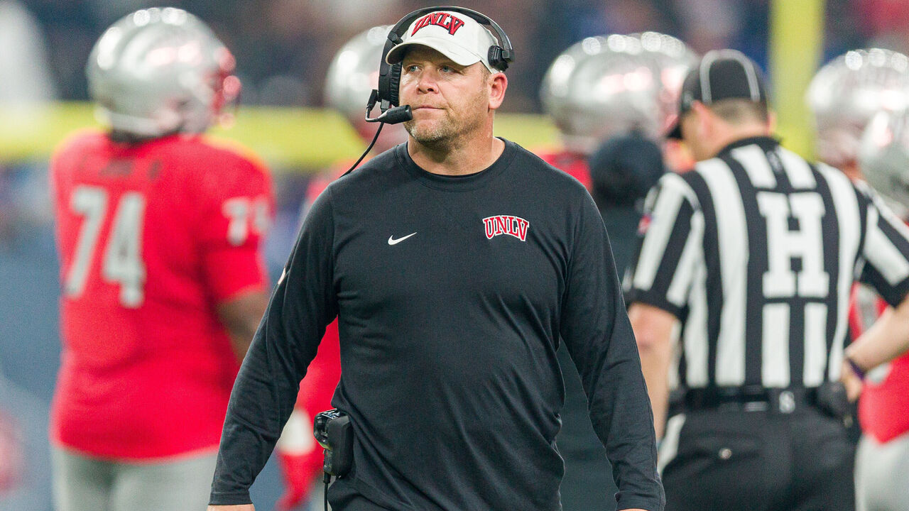 PHOENIX, AZ - DECEMBER 26: UNLV Rebels head coach Barry Odom walks on the sideline during the Guaranteed Rate Bowl college football game between the Kansas Jayhawks and UNLV Rebels on Tuesday, December 26, 2023 at Chase Field in Phoenix, AZ.