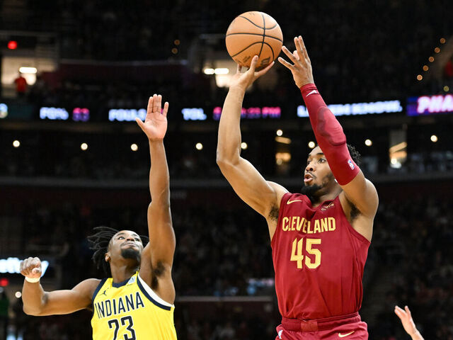 CLEVELAND, OHIO - APRIL 12: Donovan Mitchell #45 of the Cleveland Cavaliers shoots a three-point basket against Aaron Nesmith #23 of the Indiana Pacers during the first half at Rocket Mortgage Fieldhouse on April 12, 2024 in Cleveland, Ohio.