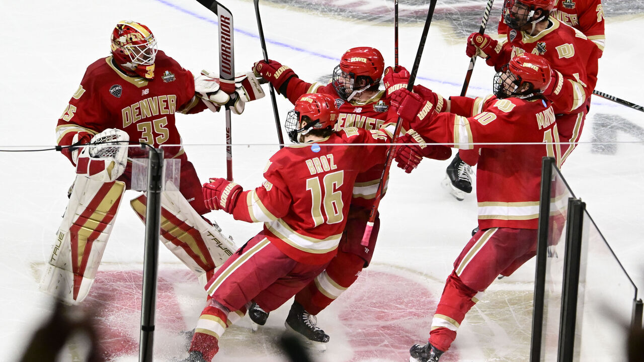 ST. PAUL, MN - APRIL 11: Denver Pioneers forward Tristan Broz (16), along with his teammates celebrate with Denver Pioneers goaltender Matt Davis (35) after Broz scored the game winning overtime goal against the Boston University Terriers during the 2024 NCAA Frozen Four semifinal at Xcel Energy Center in St. Paul, Minnesota on Thursday, April 11, 2024. The Pioneers won 2-1 to move on to Saturdays championship game.