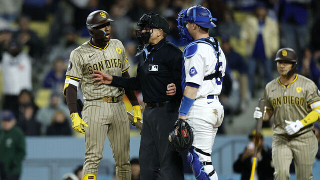 LOS ANGELES, CALIFORNIA - APRIL 13: Home plate umpire Chris Guccione #68 separates catcher Will Smith #16 of the Los Angeles Dodgers from Jurickson Profar #10 of the San Diego Padres after they had words during the fifth inning at Dodger Stadium on April 13, 2024 in Los Angeles, California.