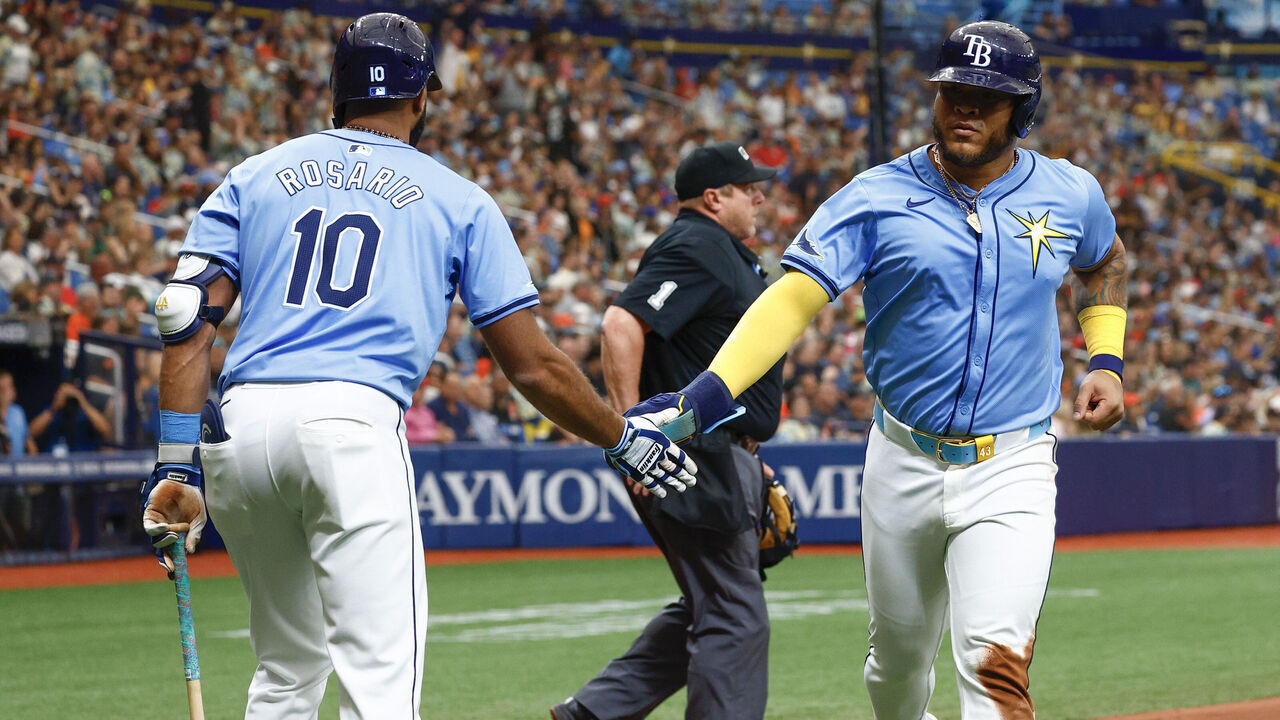 ST PETERSBURG, FLORIDA - APRIL 14: Isaac Paredes #17 of the Tampa Bay Rays celebrates with teammate Amed Rosario #10 after scoring during the third inning against the San Francisco Giants at Tropicana Field on April 14, 2024 in St Petersburg, Florida.