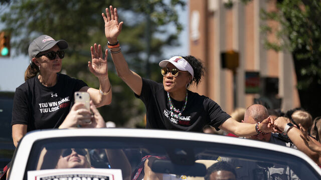 COLUMBIA, SOUTH CAROLINA - APRIL 14: South Carolina coach Dawn Staley, right, and Lisa Boyer wave to fans during a NCAA Women's Basketball Championship parade on April 14, 2024 in Columbia, South Carolina. Staley has won three national championships as coach of the South Carolina Gamecocks and led the team to an undefeated season this year.