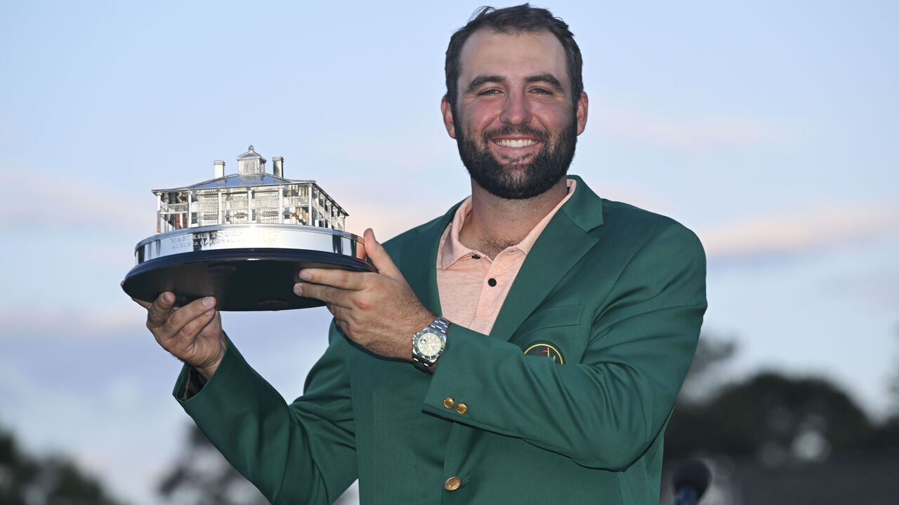 AUGUSTA, GEORGIA - APRIL 14: Scottie Scheffler poses with the winner's trophy as the 2024 Masters Champion after the final round of Masters Tournament at Augusta National Golf Club on April 14, 2024 in Augusta, Georgia.