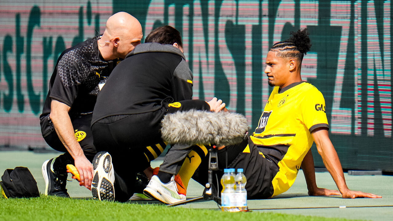 MOENCHENGLADBACH, GERMANY - APRIL 13: Sebastien Haller of Borussia Dortmund receives medical treatment during the Bundesliga match between Borussia Mönchengladbach and Borussia Dortmund at Borussia Park Stadium on April 13, 2024 in Moenchengladbach, Germany.