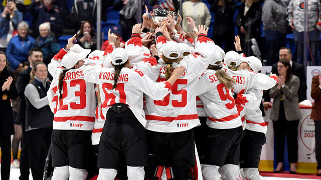 UTICA, NEW YORK - APRIL 14: Team Canada raises the Championship Trophy after winning The Gold by defeating The United States in OT during the 2024 IIHF Women's World Championship Gold Medal game at Adirondack Bank Center on April 14, 2024 in Utica, New York.
