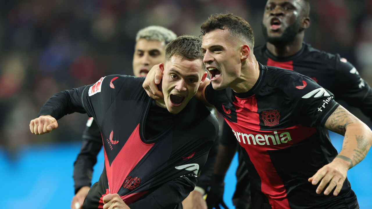 LEVERKUSEN, GERMANY - DECEMBER 3: Florian Wirtz of Bayer 04 Leverkusen (L) celebrates with teammate Granit Xhaka, but the goal is not given during the Bundesliga match between Bayer 04 Leverkusen and Borussia Dortmund at BayArena on December 3, 2023 in Leverkusen, Germany.