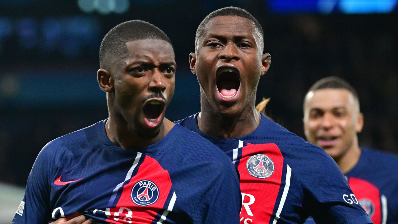 PARIS, FRANCE - APRIL 10: Ousmane Dembelé of PSG celebrate goal and Nuno Mendes of PSG in action during the UEFA Champions League quarter-final first leg match between Paris Saint-Germain and FC Barcelona at Parc des Princes on April 10, 2024 in Paris, France.